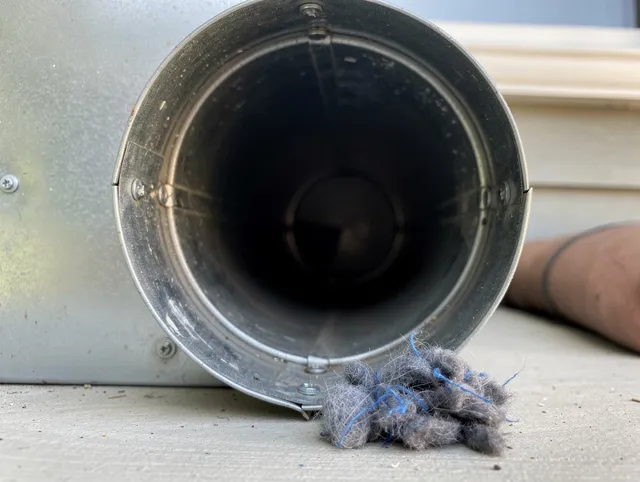 North Smithfield Dryer Vent Cleaning technician using specialized equipment to clear severe dryer vent blockage in North Smithfield